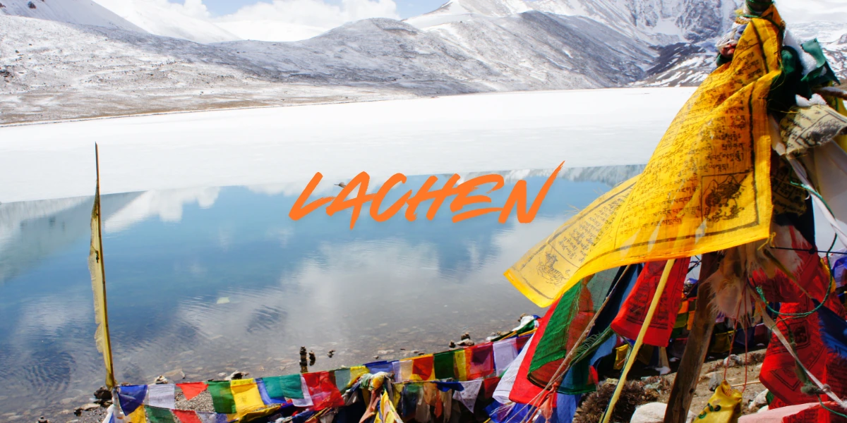 Lachen village in North Sikkim with snow-covered mountains, frozen lake and colorful prayer flags in February
