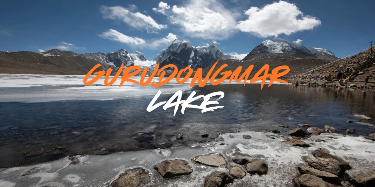 Gurudongmar Lake in North Sikkim with frozen water, snow-covered mountains and clear blue sky in February